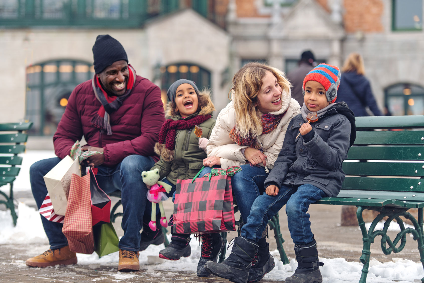 A family sitting on a bench.