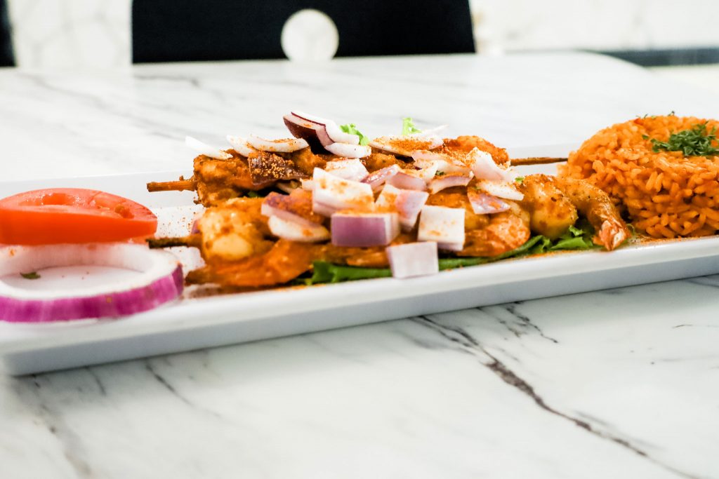 A close up of grilled shrimps on skewers.