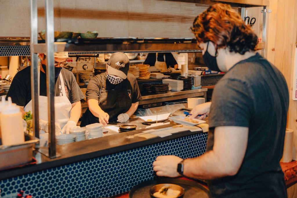 A person taking orders from the kitchen.