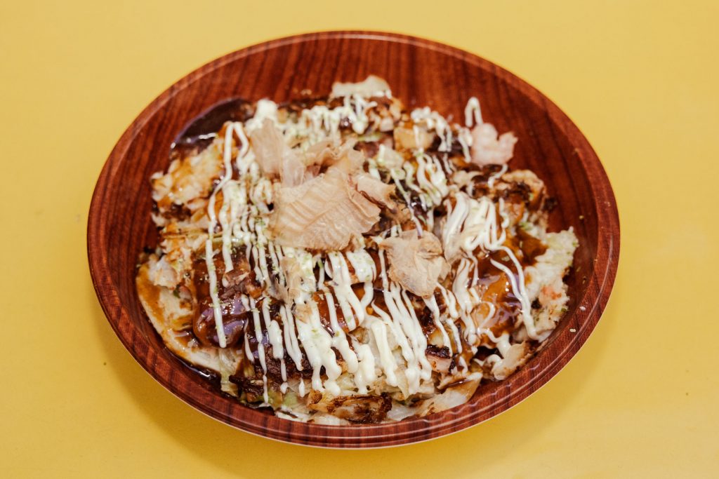 A Japanese dish set in a large wooden plate.