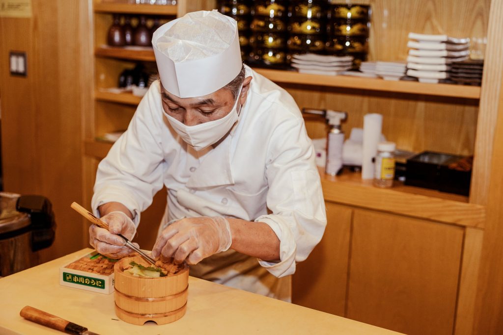 A chef delicately plating an ornate dish.