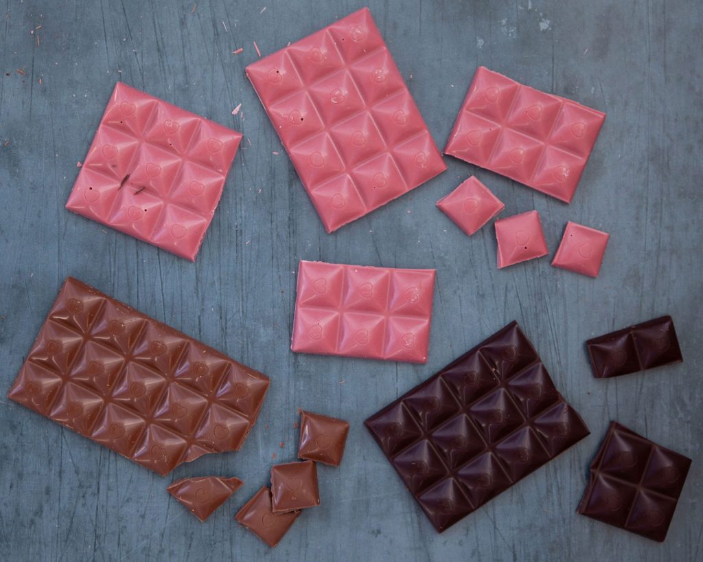 Decorated bars of ruby, dark and milk chocolate.
