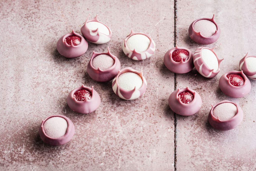 A table of delicate ruby chocolate candies.
