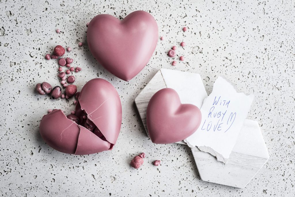 A table of ruby chocolate hearts.
