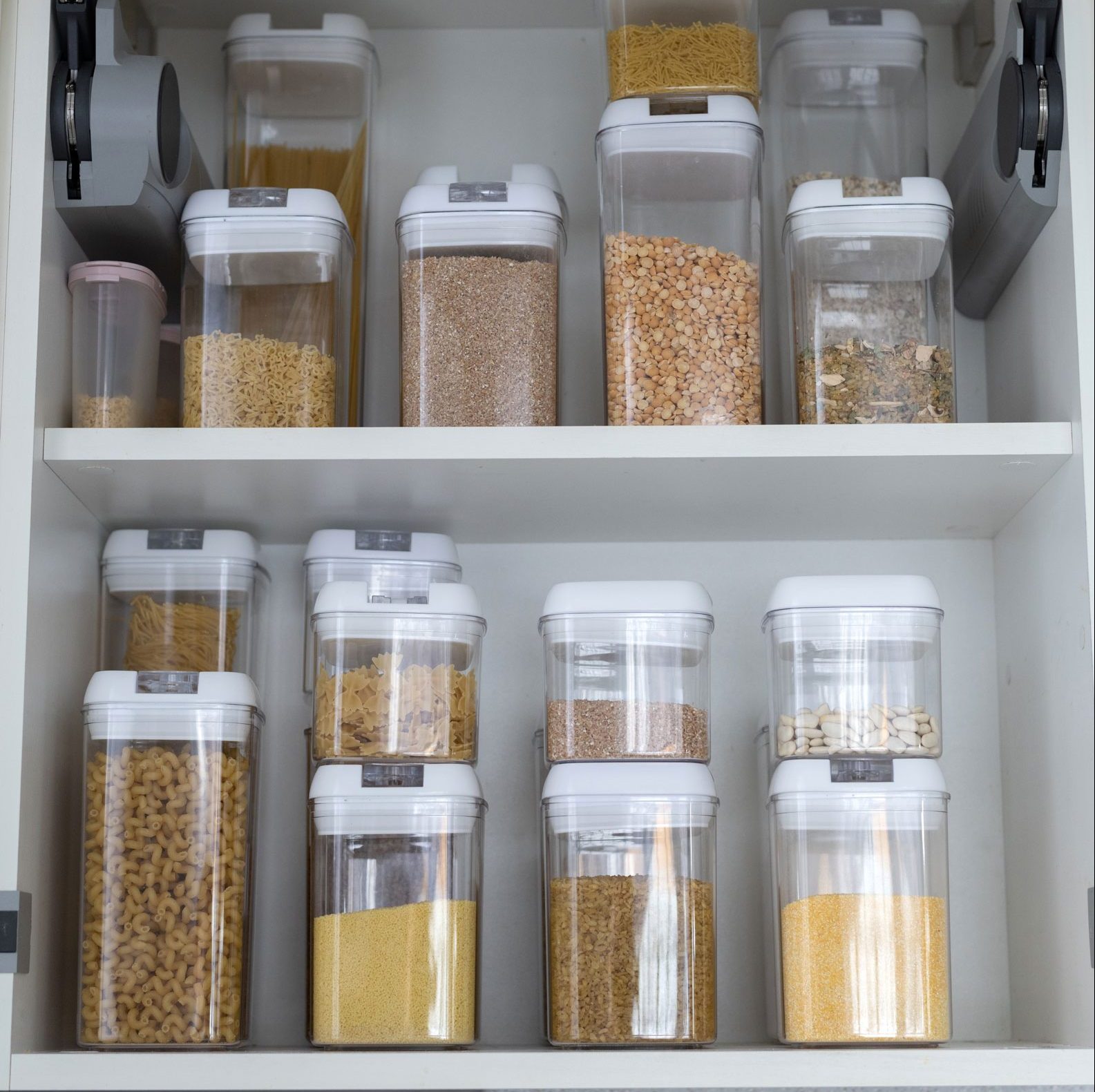 Organized containers of dried pastas and grain.
