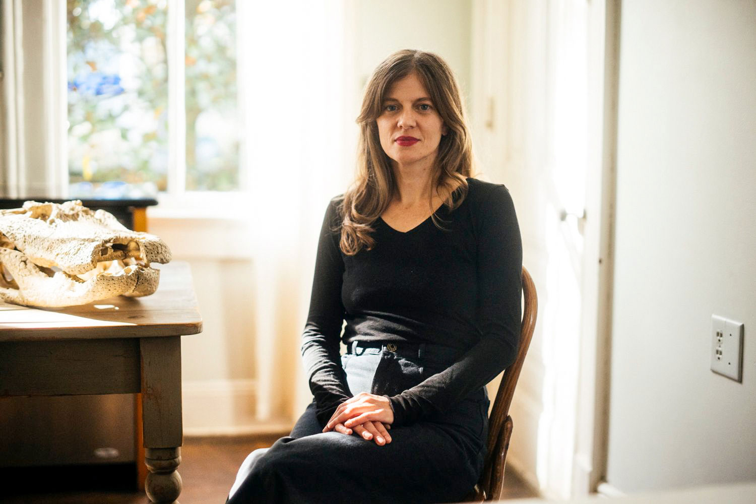 Melissa M. Martin sitting next to a kitchen table.