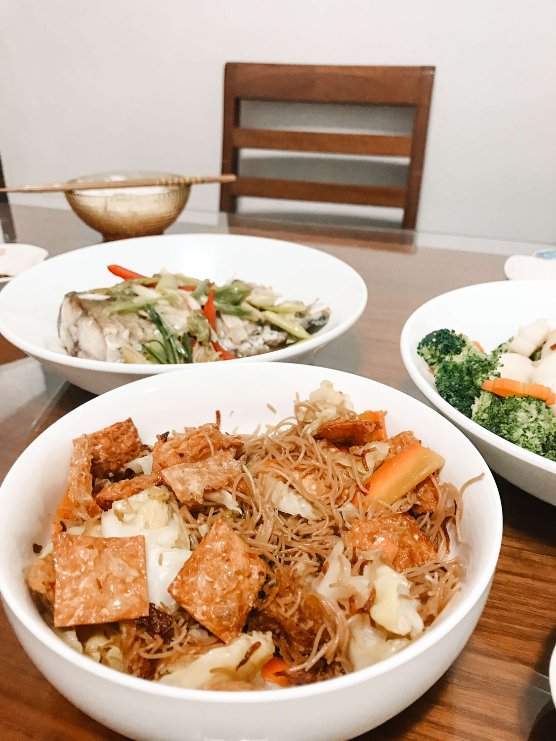 Three large serving dishes filled to the brim with food.
