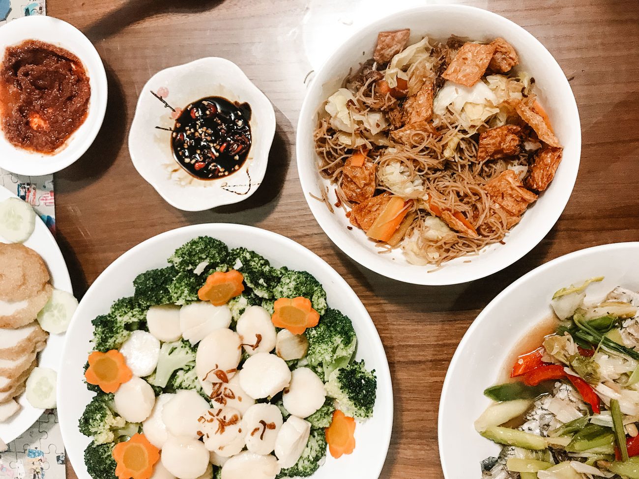 A dinner table with a variety of home cooked dishes.