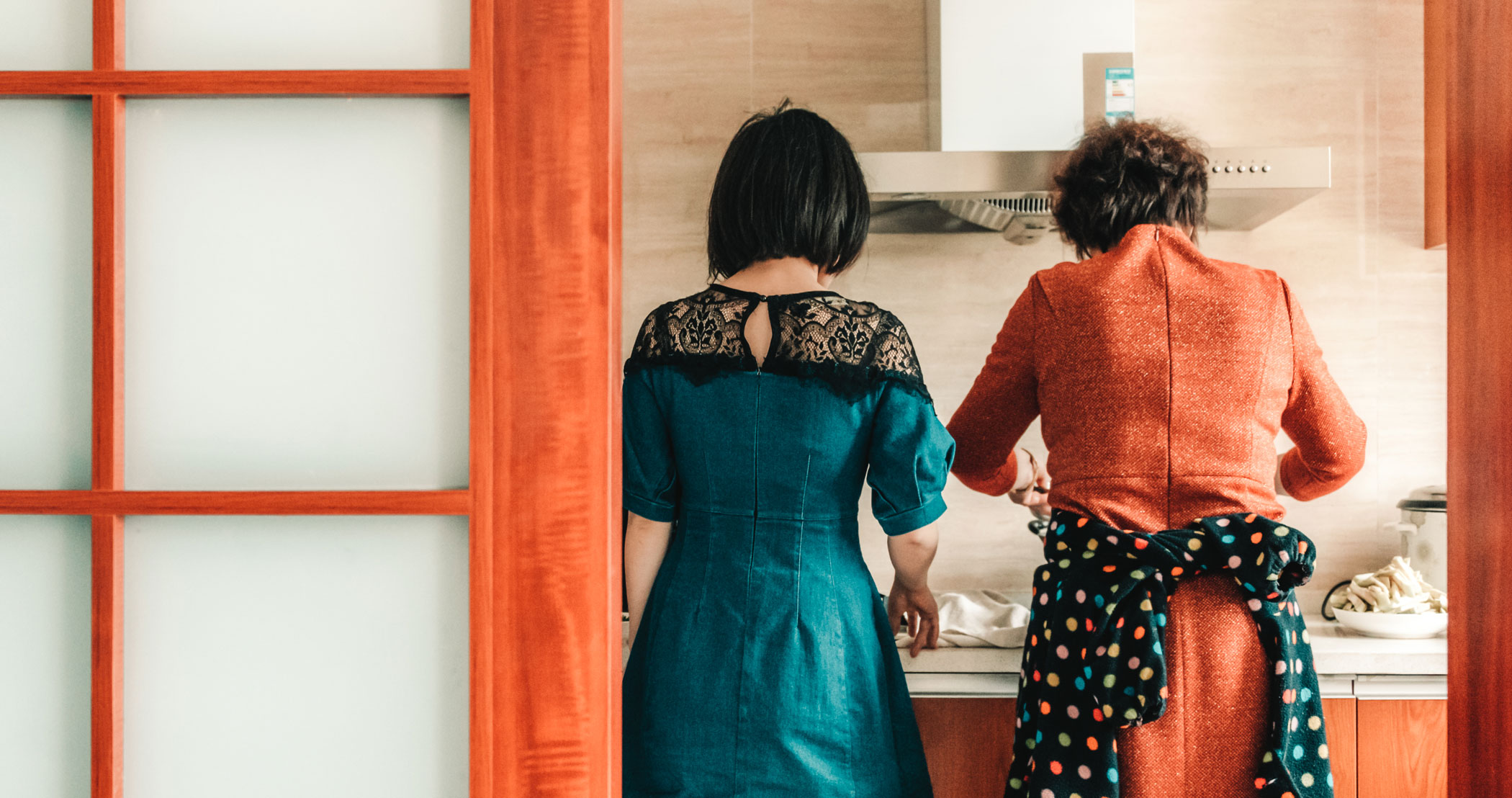 A mom and daughter enjoying cooking together.