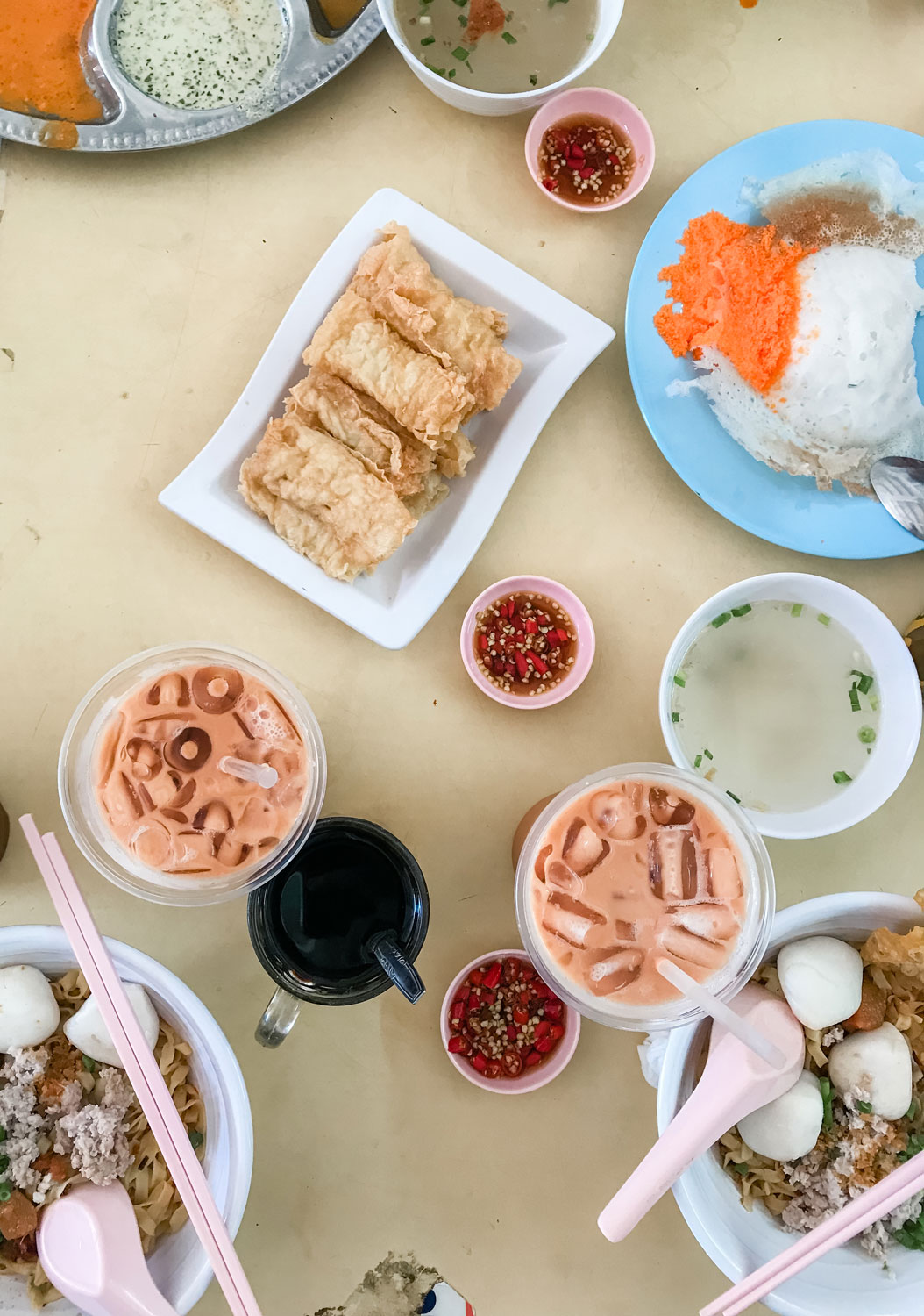 A table with drinks and different dishes.