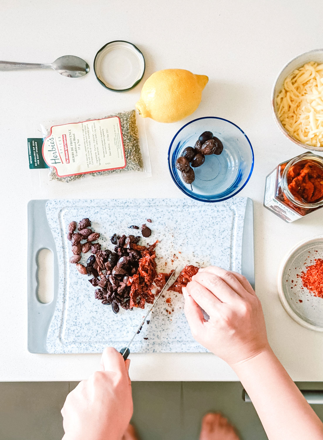 Chopping up ingredients for focaccia bread.