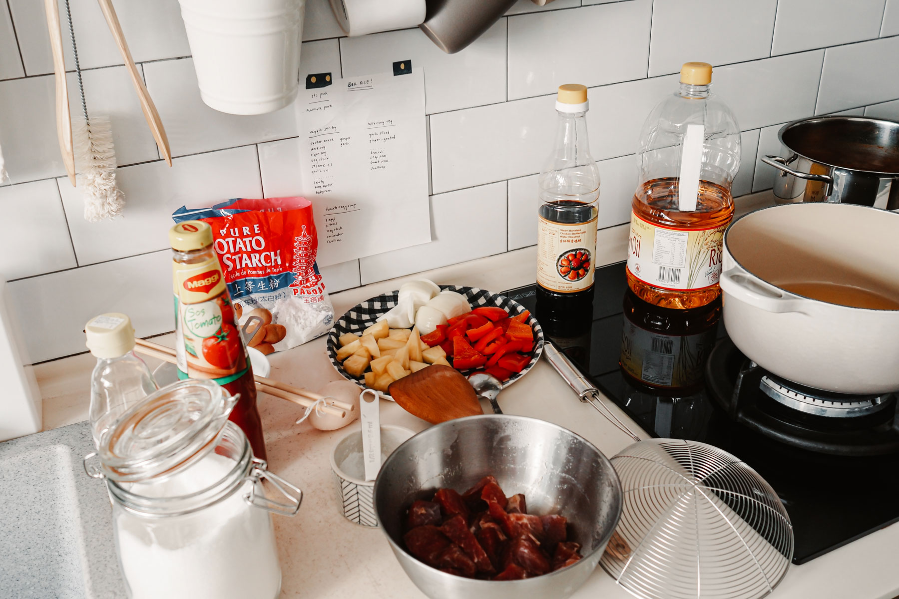 A countertop scattered with ingredients for sweet and sour pork.