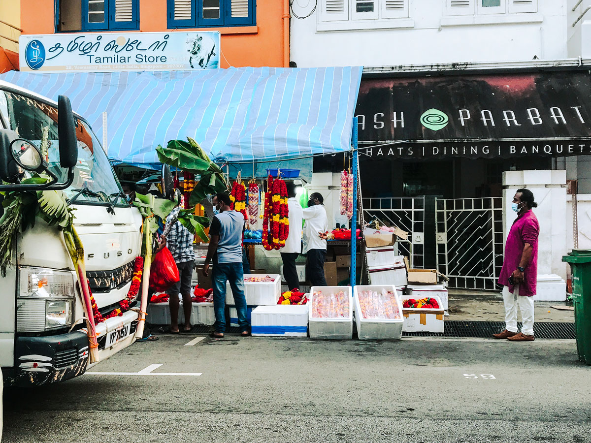 People ordering food at a small Indian food stall.