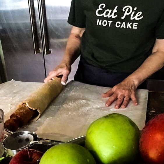 Rolling out pie crust.