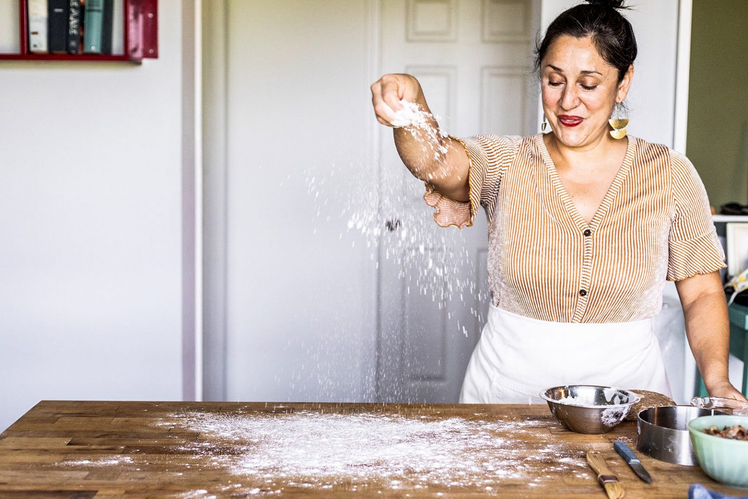 Spreading flour on a table.