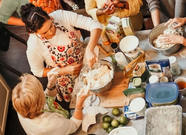 A family cooking together in a kitchen.