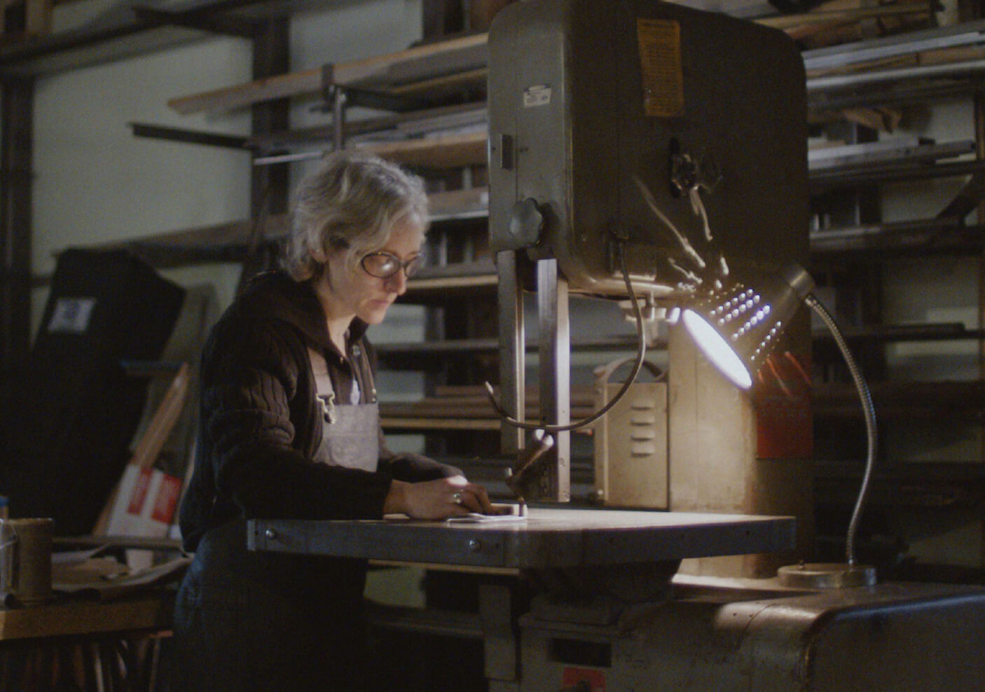 Erica focusing on her work in her shop.