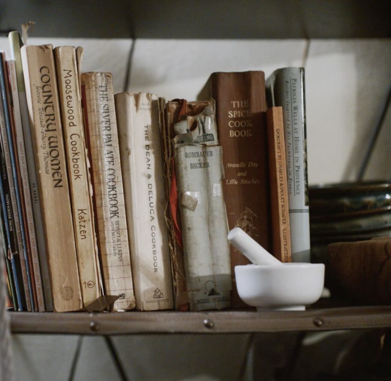 A shelf filled with Erica's avidly used cookbooks