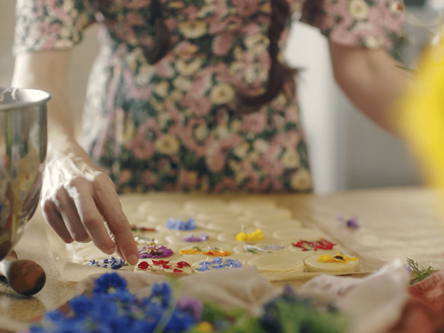 Loria Stern pressing edible flowers into cookies.