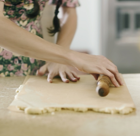 Loria Stern gently rolling out dough.