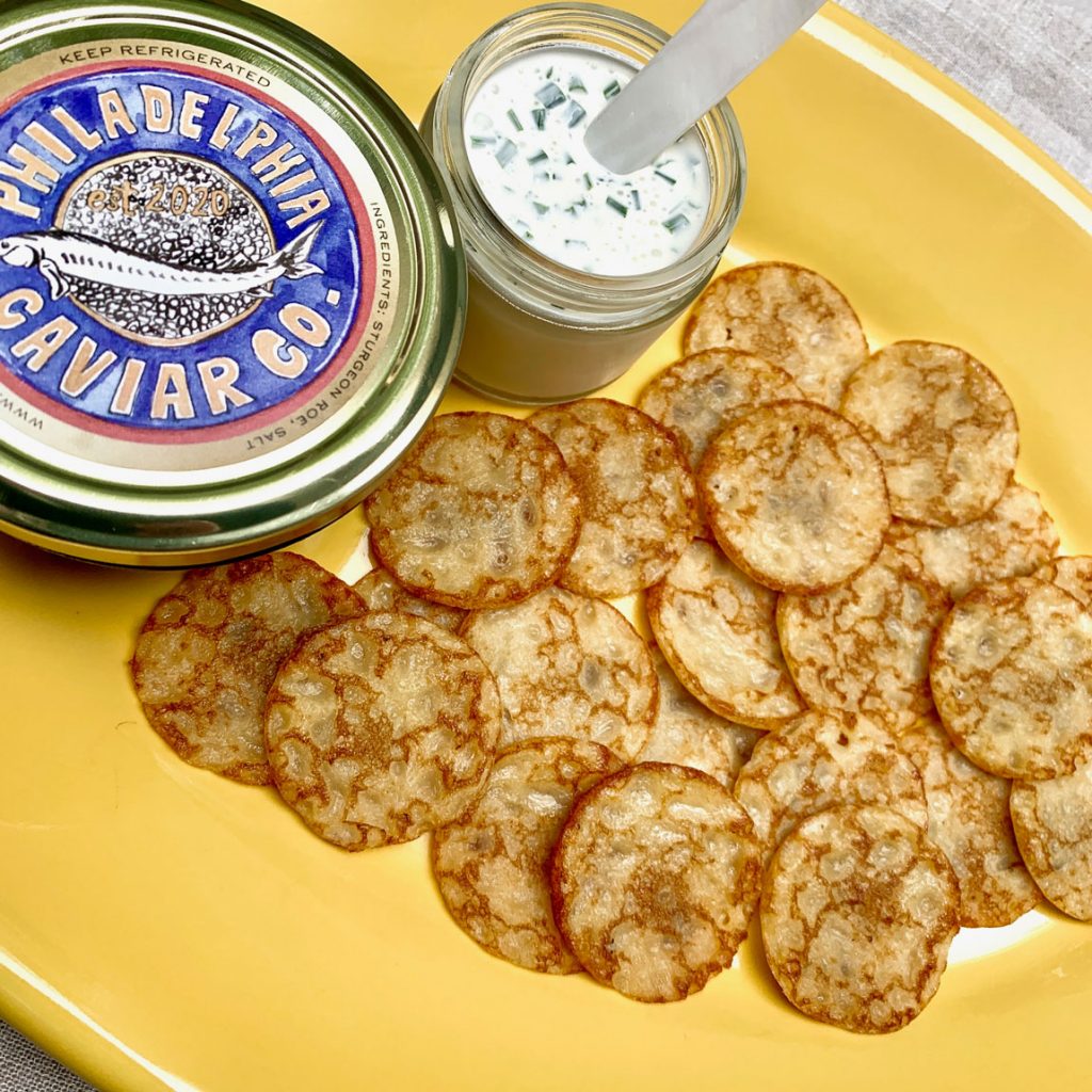 A large plate of freshly made blinis.