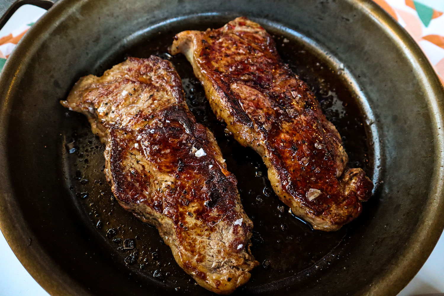 Two slabs of meat sprinkled with salt.