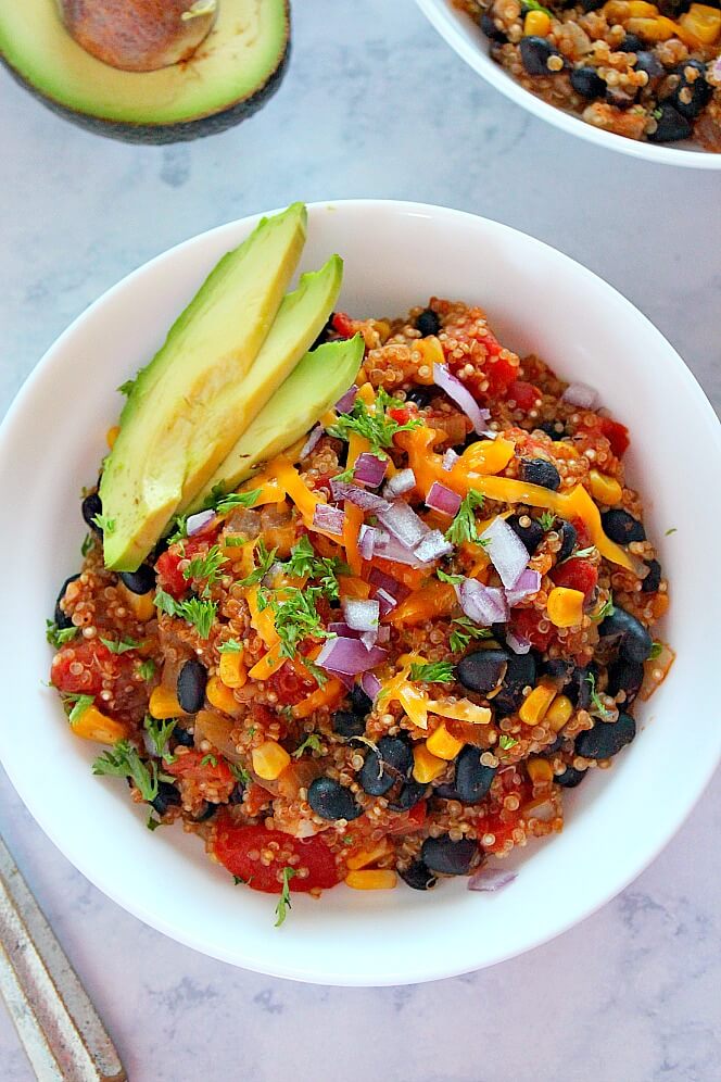 A bowl of colorful Tex-Mex cuisine with corn, avocado and other ingredients.