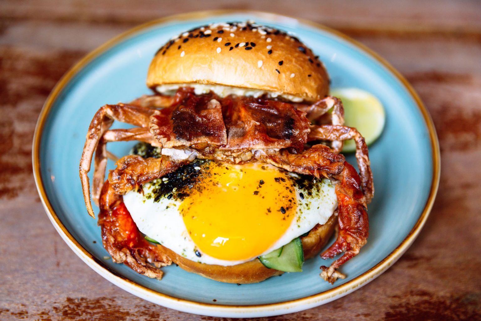 A delicious crab burger with a freshly fried egg.