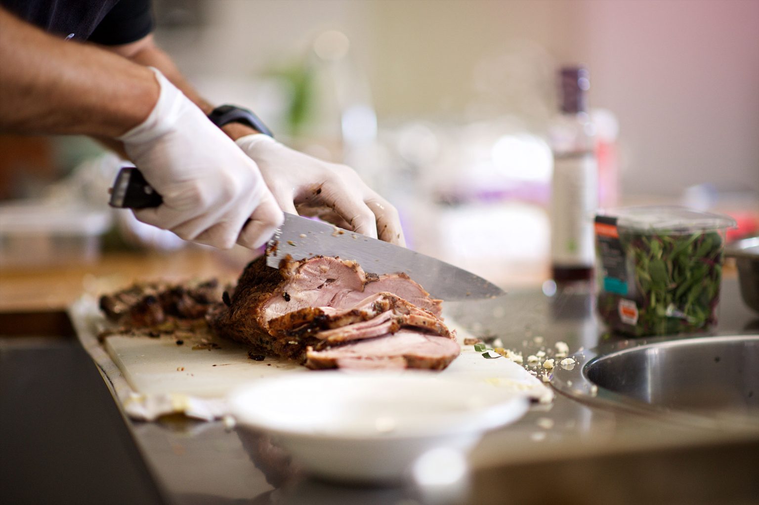 A person slicing the iconic beef pit known to Baltimore.