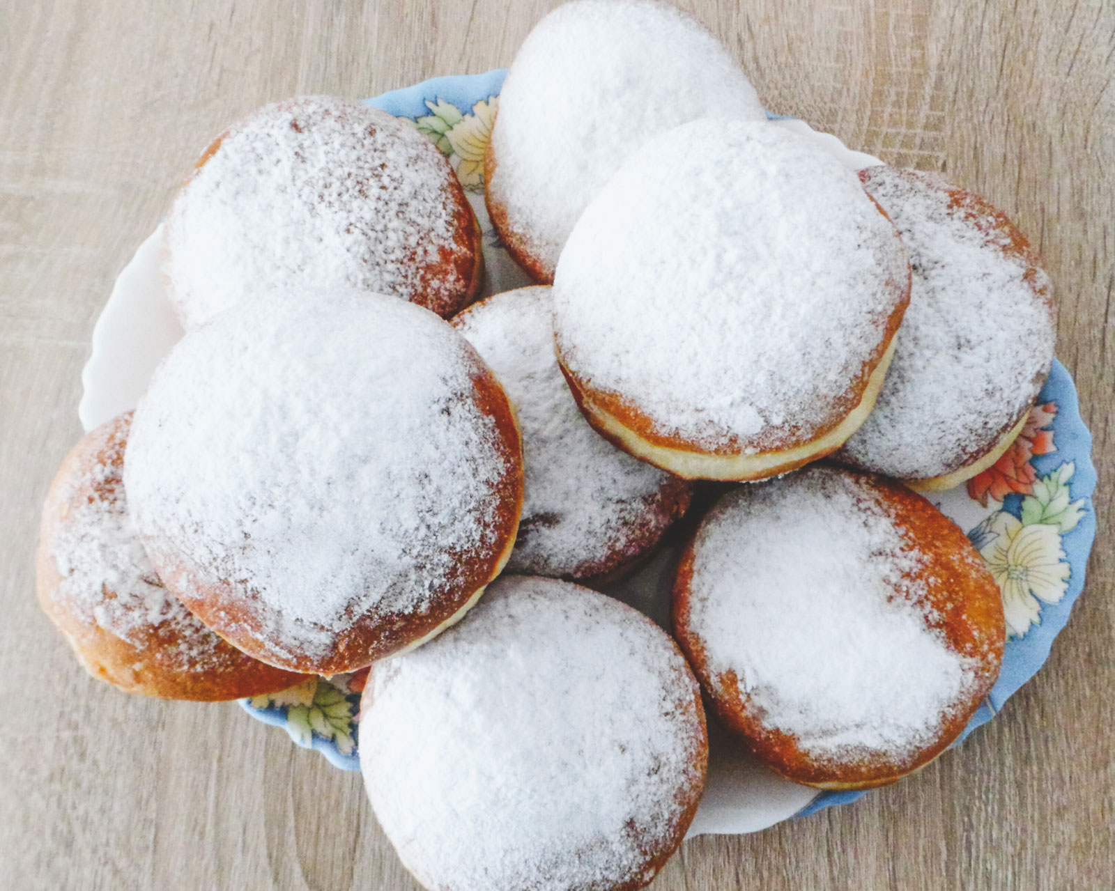 A large plate overwhelmed with delicious Paczki.