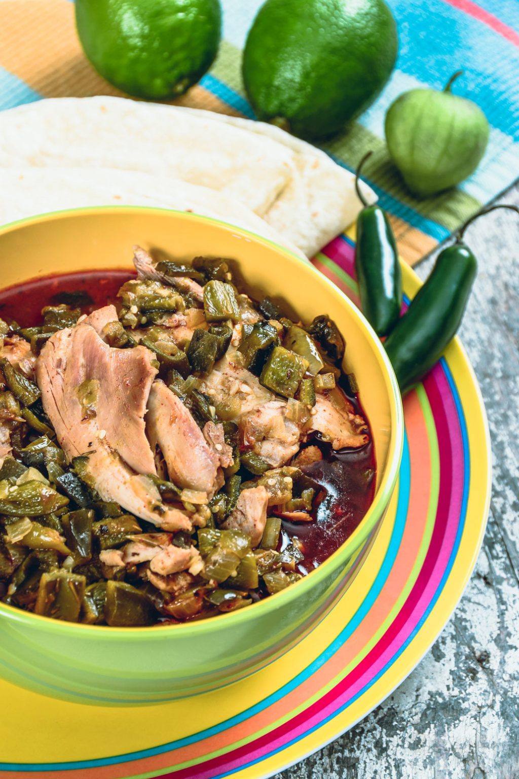 A colorful bowl of green chili made with pork.