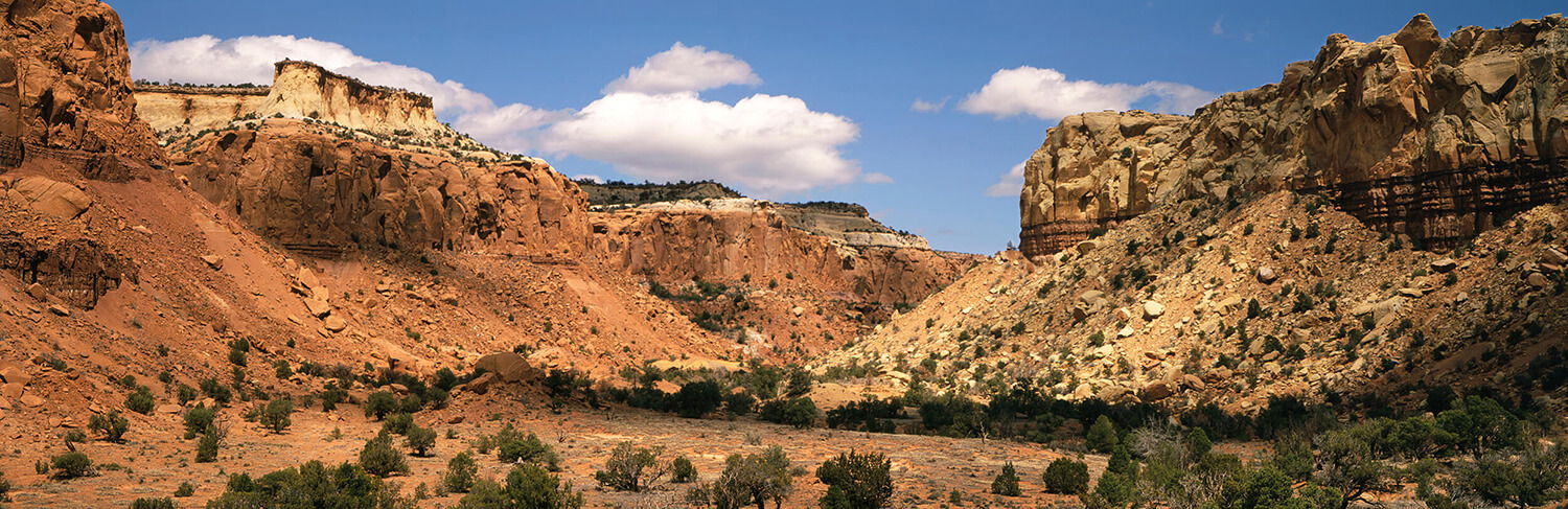 Santa Fe's red rock formations under a sunny, blue sky.