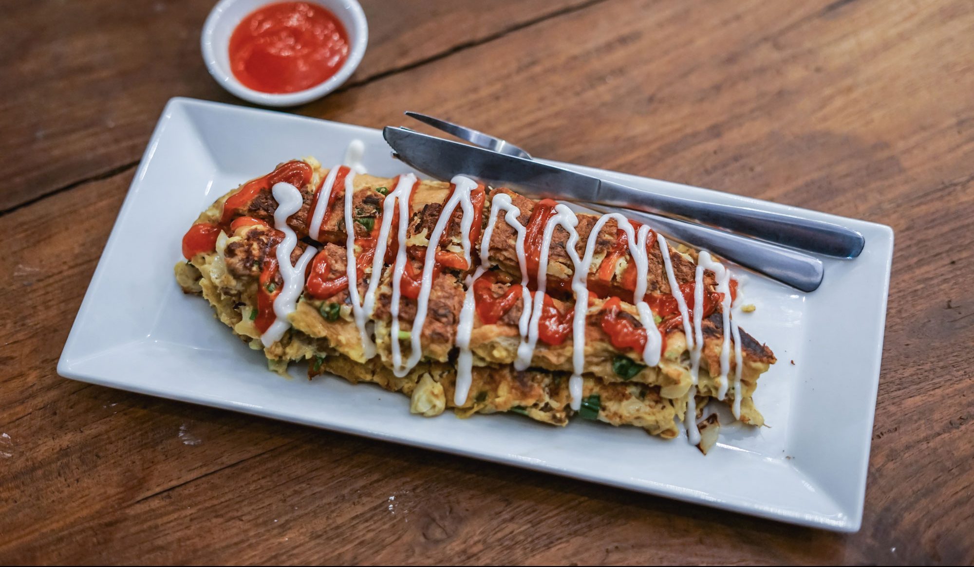 A Singaporean omelette sandwich on a white dish.