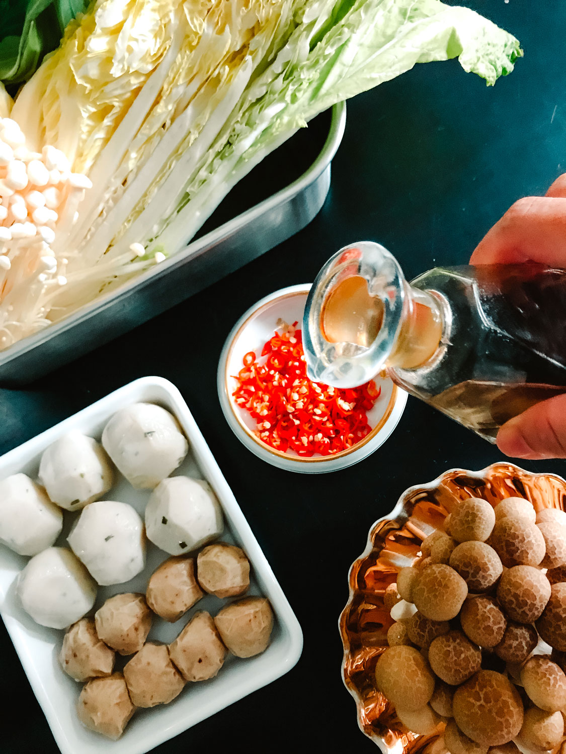 A small dish of chopped chili rings amongst other ingredients.