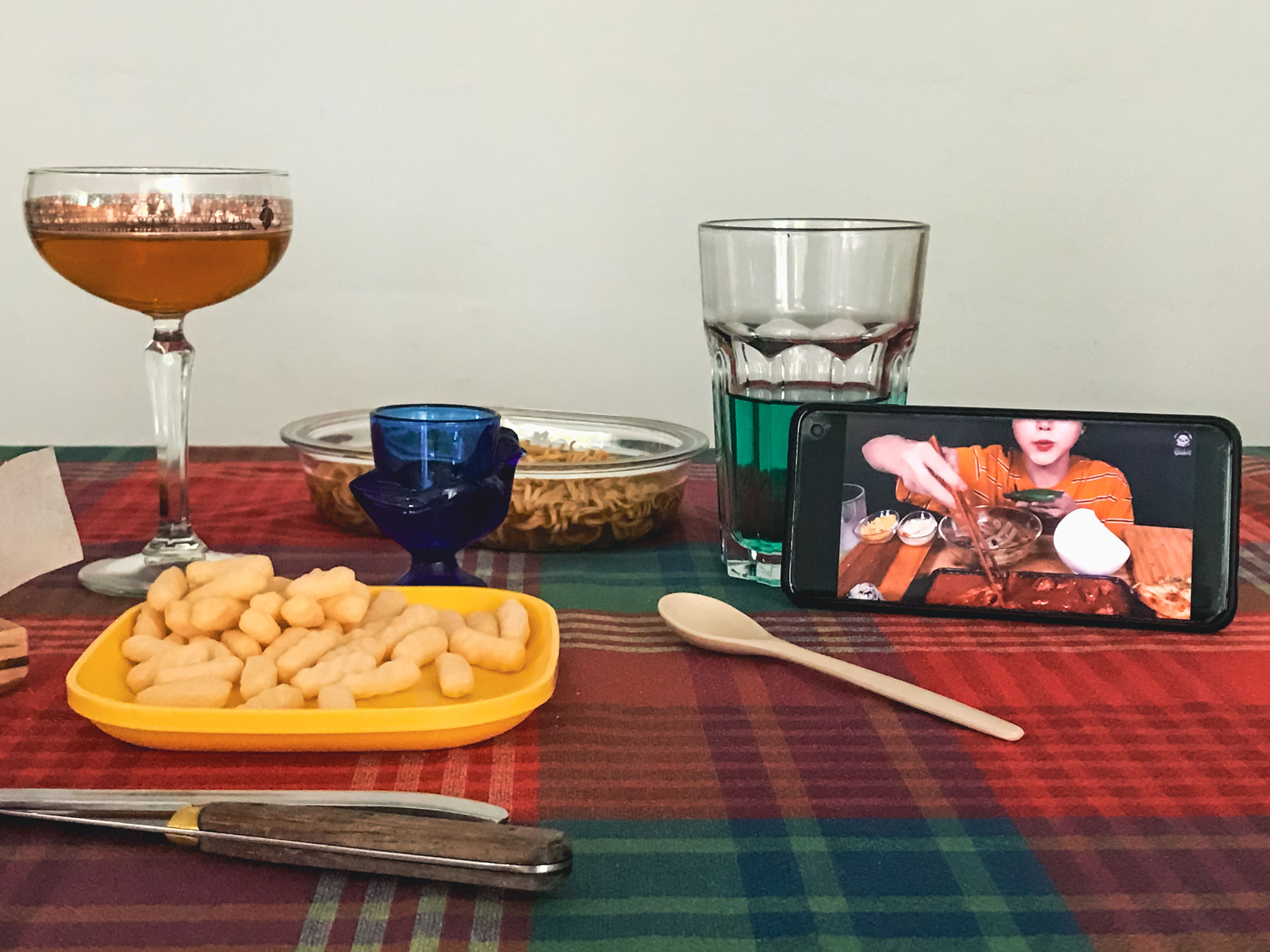 A table set for one with an open smart phone on the table.