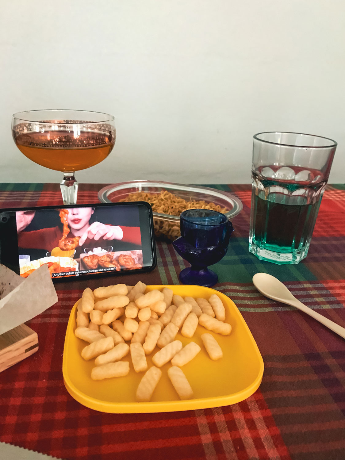 Food set out on a table with a smart phone open.