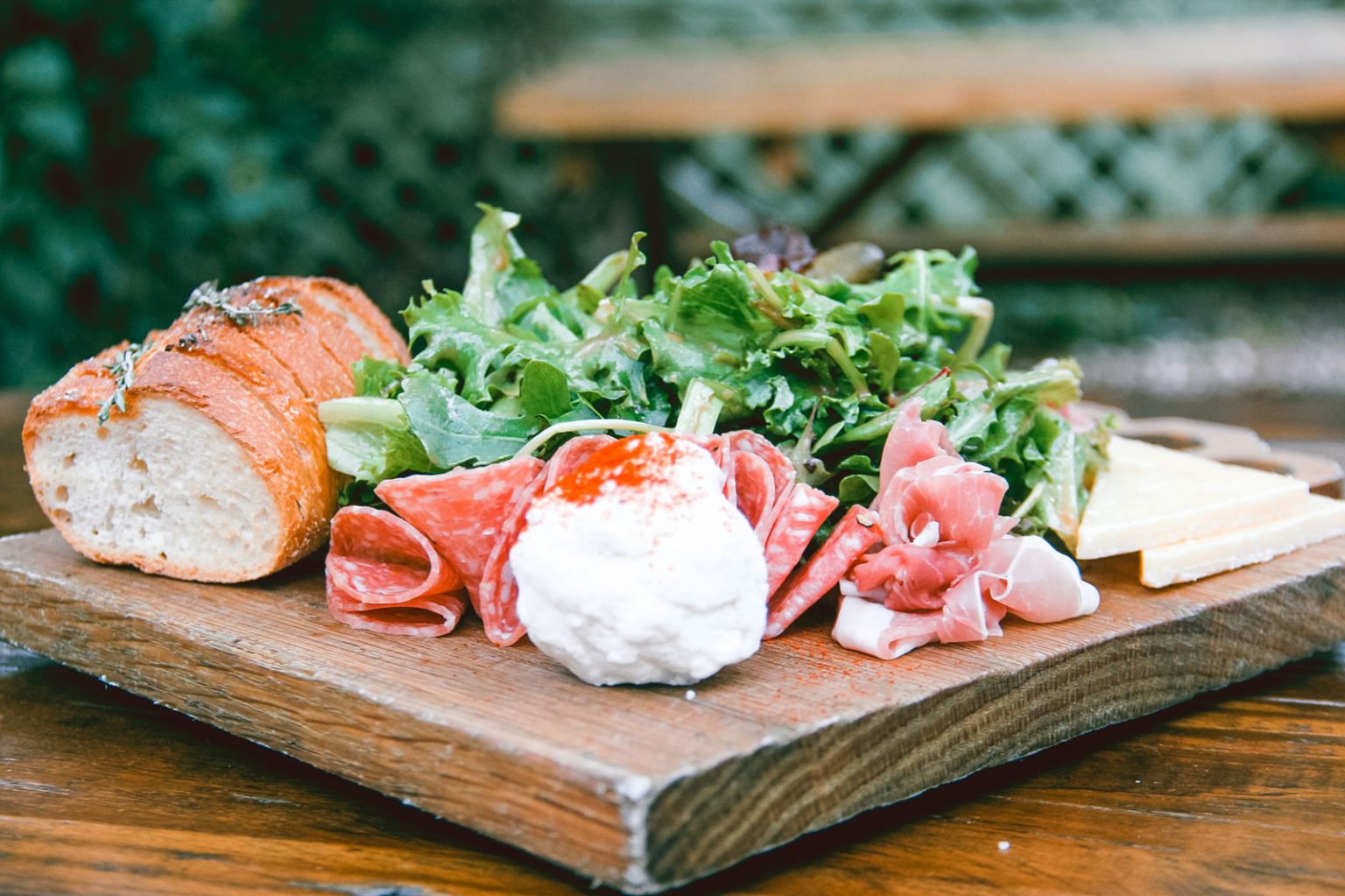 Close-up of salami and cheese board.
