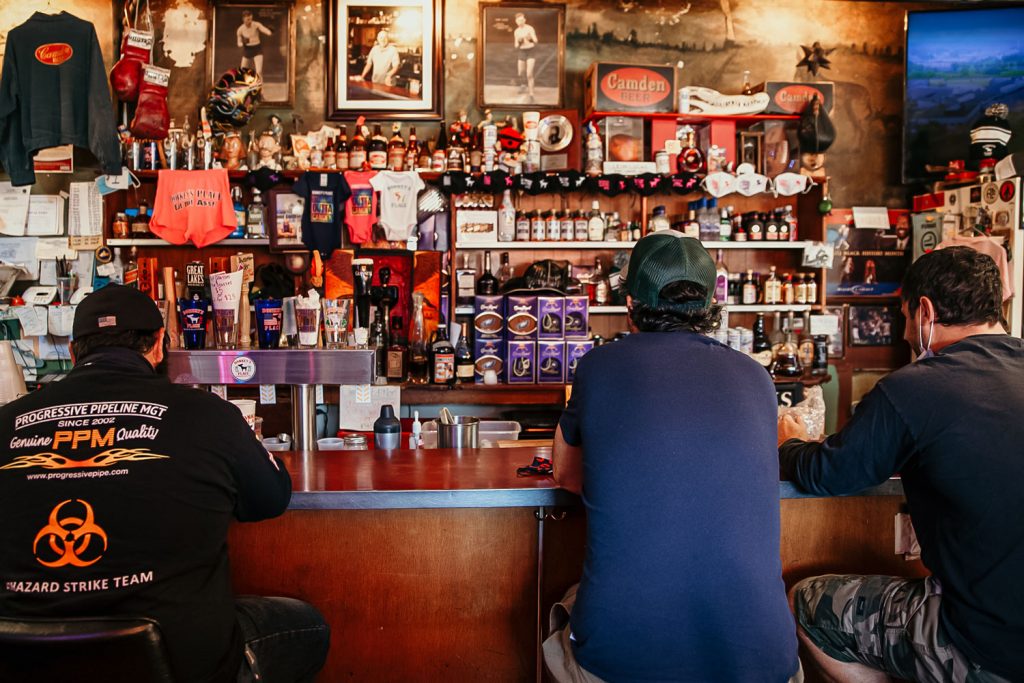 People sitting at the well-stocked bar of Donkey's Place.