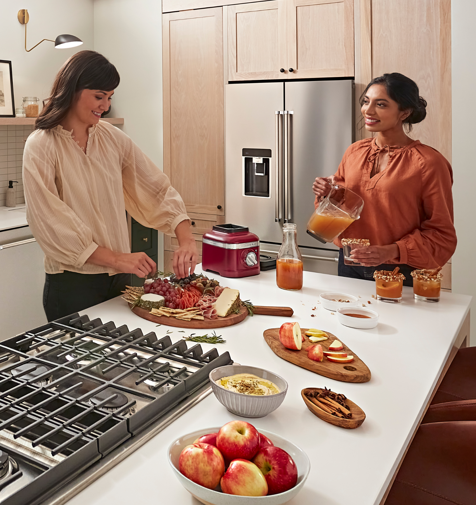 Friends preparing a charcuterie board and pouring drinks
