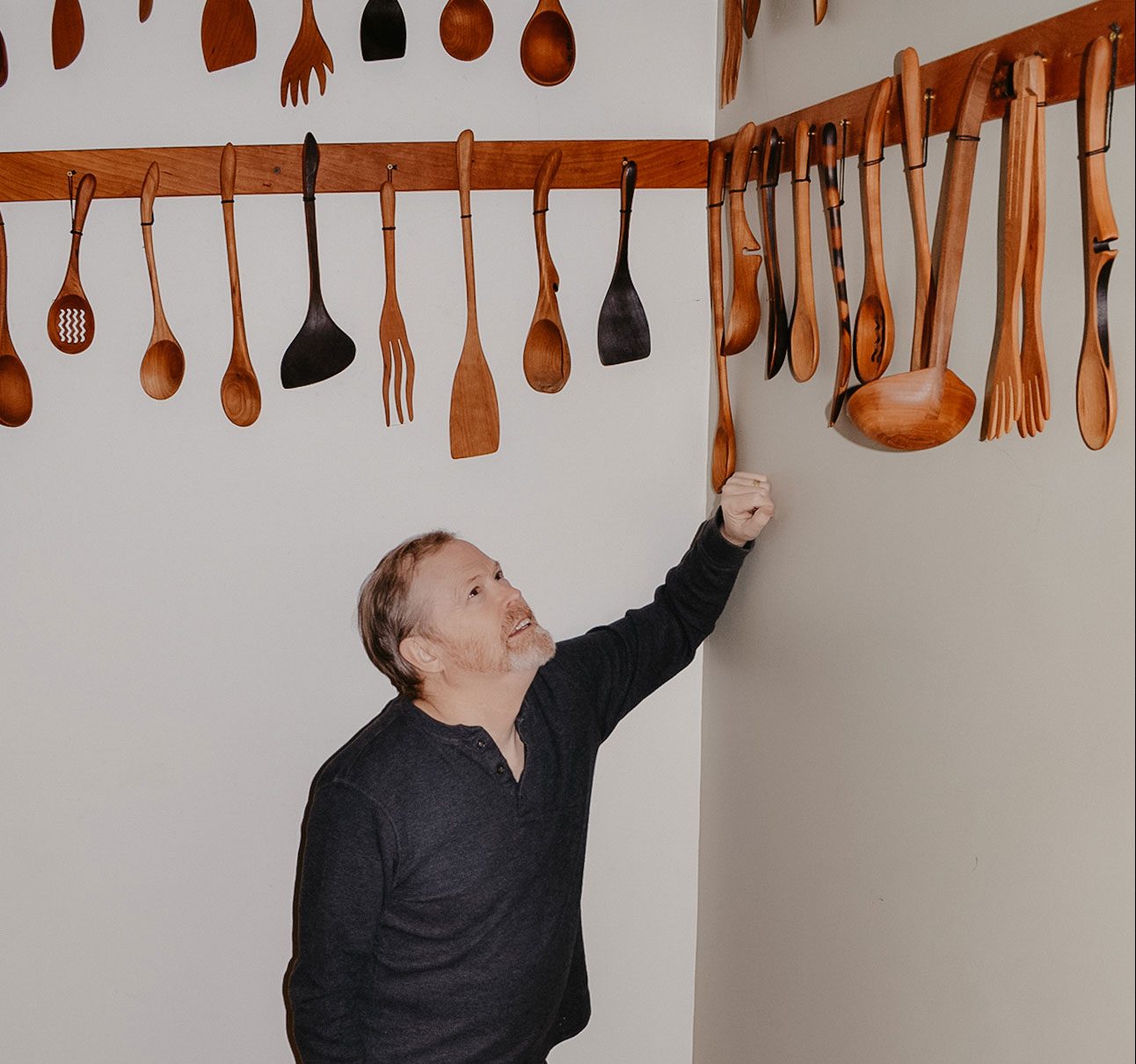 Jonathan Simons showing off his collection of wooden utensils.