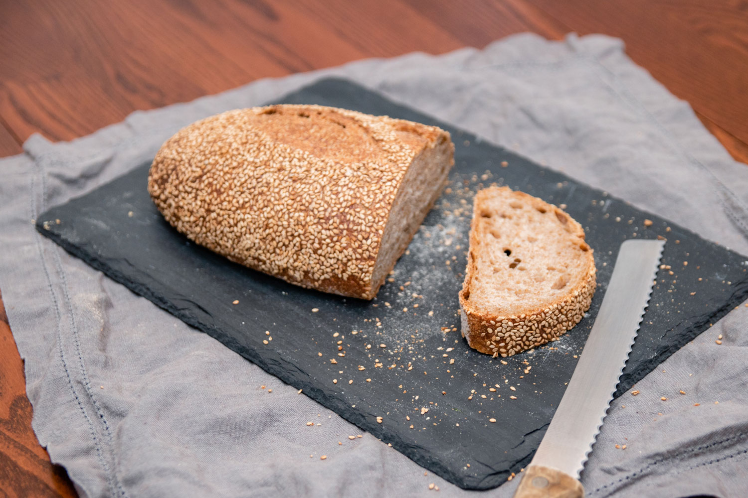 A loaf of bread with single slice cut off.