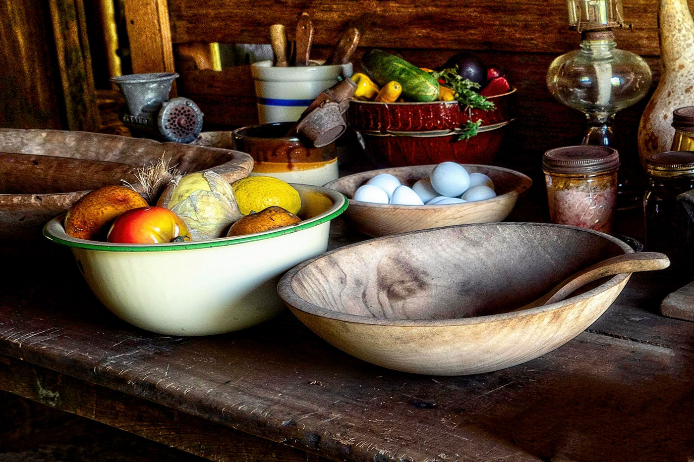 A variety of bowls filled with eggs, vegetables and other items.