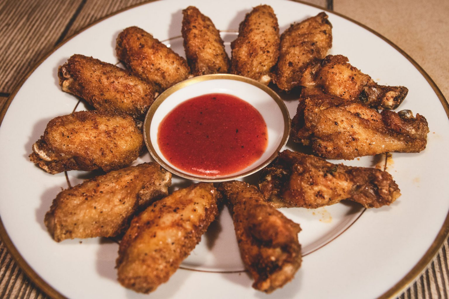 A plate of fried chicken legs and drums.