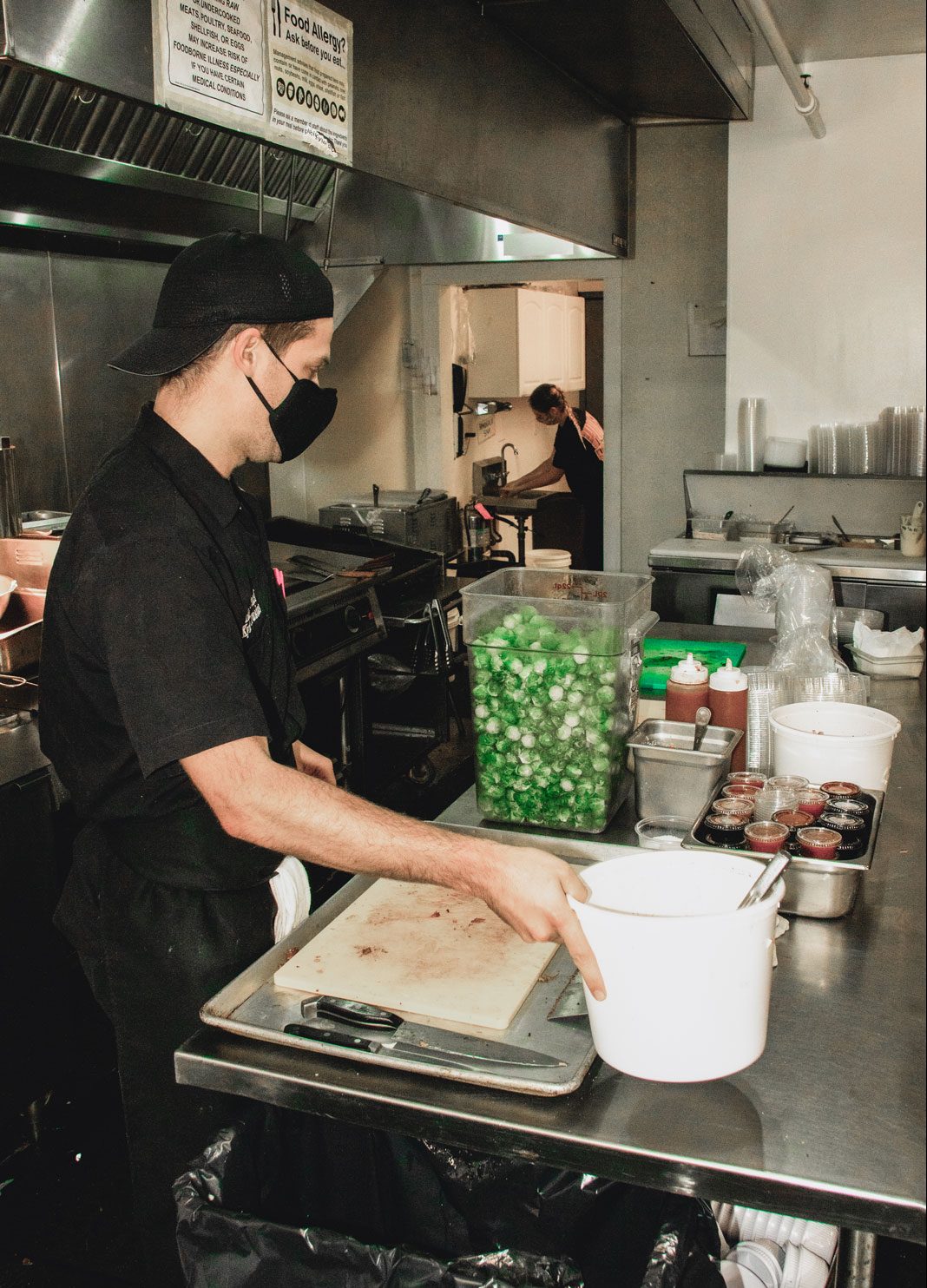 A man working diligently in the restaurant's kitchen.