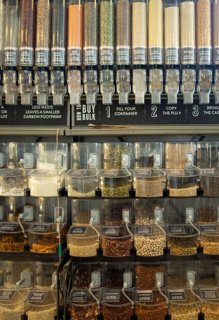 A variety of different grains and beans in their own individual containers.