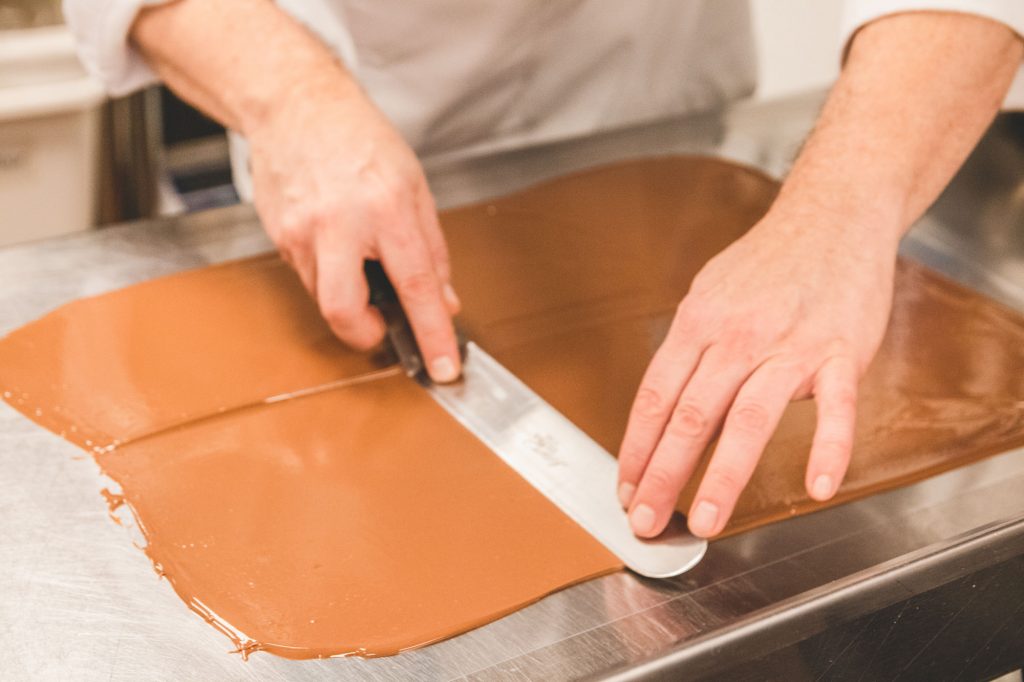 Chef Christophe Toury skillfully spreading chocolate.