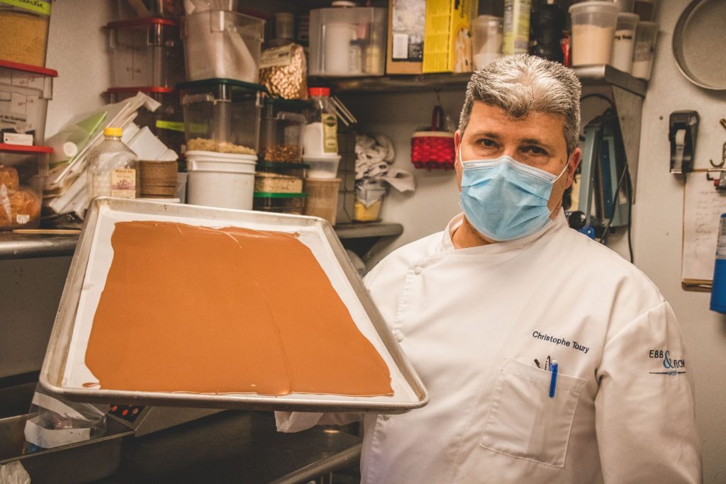 Chef Christophe Toury holding a sheet of chocolate.