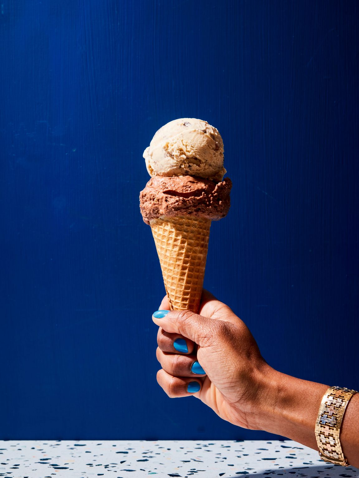 A person holding an ice cream cone.