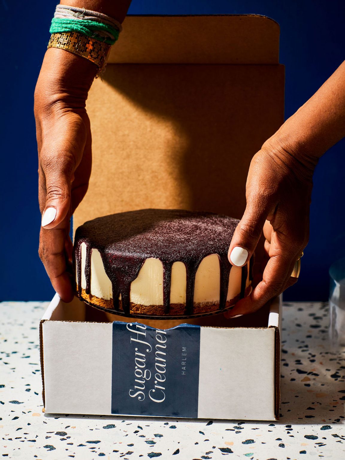 A person placing ice cream cake into a box.