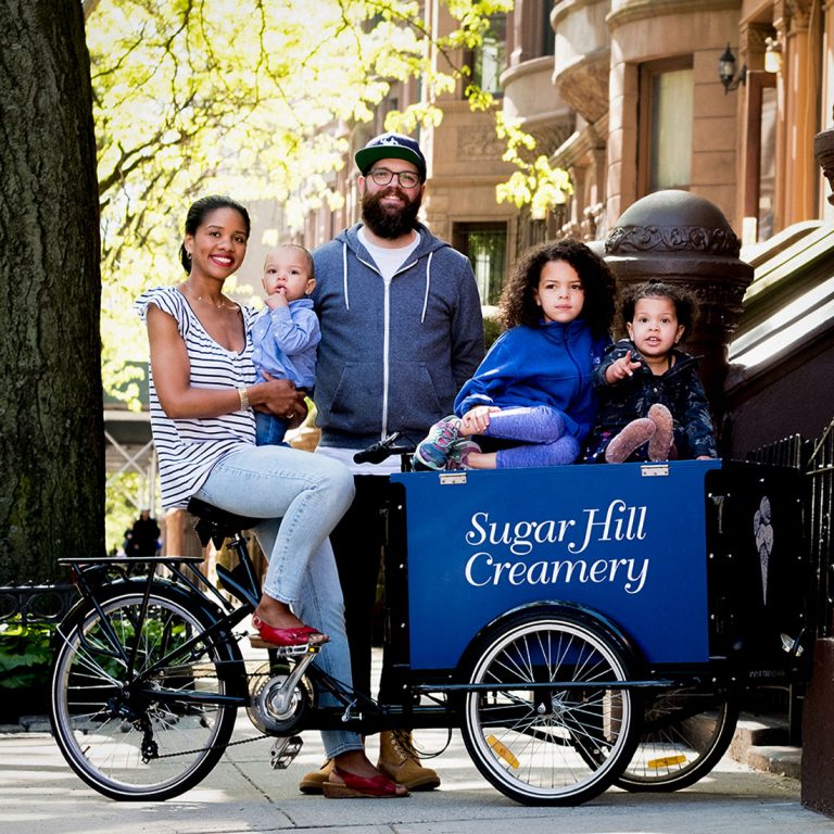 Petrushka and Nick posing for a photo with their family.